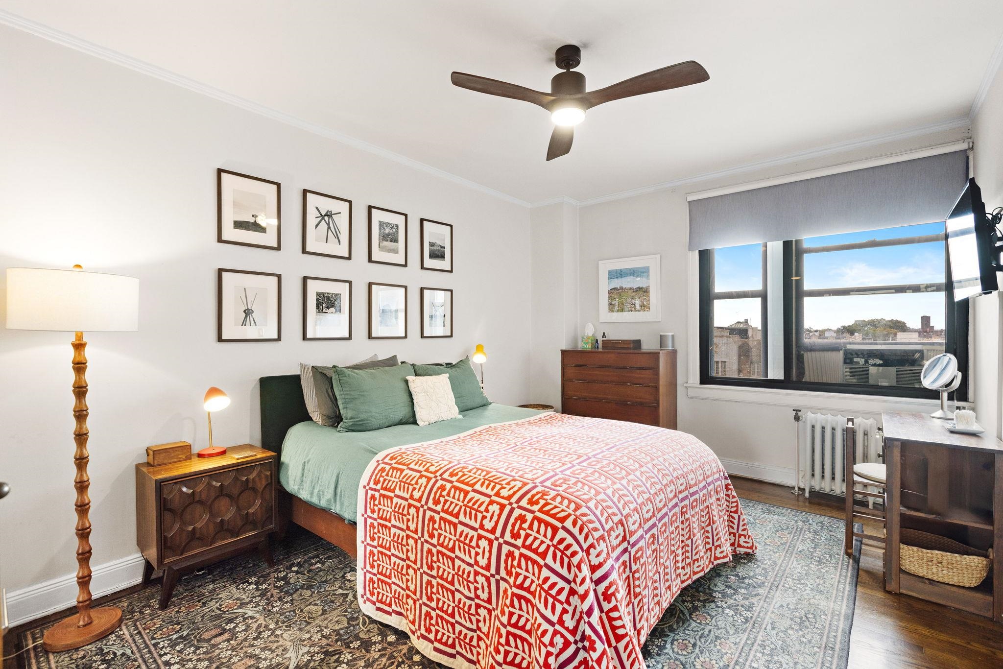 2600 John F. Kennedy Boulevard, Unit 7F Jersey City, NJ 07306 - Photo 4 of 22 a bedroom with a large bed a chandelier and a view of en suite bathroom