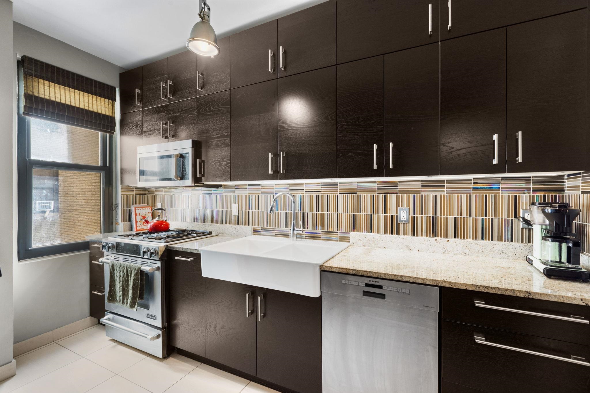 2600 John F. Kennedy Boulevard, Unit 7F Jersey City, NJ 07306 - Photo 6 of 22 a kitchen that has a lot of cabinets in it and wooden floor