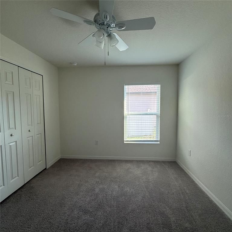 1542 Log Lane North Port, FL 34286 - Photo 20 of 27 an empty room with a window and a fan