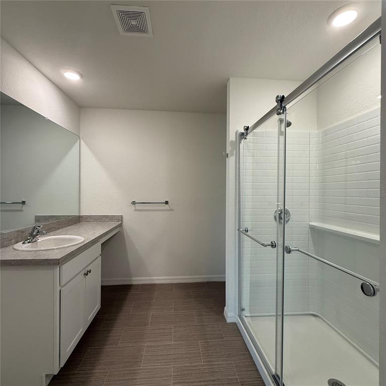 1542 Log Lane North Port, FL 34286 - Photo 24 of 27 a bathroom with a granite countertop sink mirror and shower