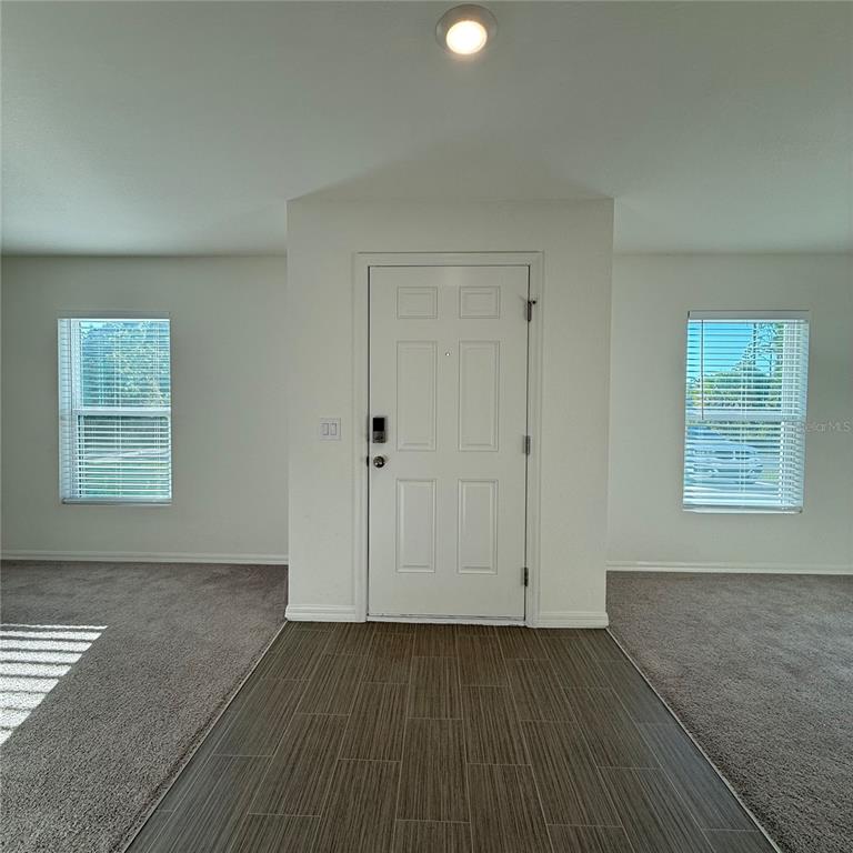 1542 Log Lane North Port, FL 34286 - Photo 8 of 27 an empty room with wooden floor and windows