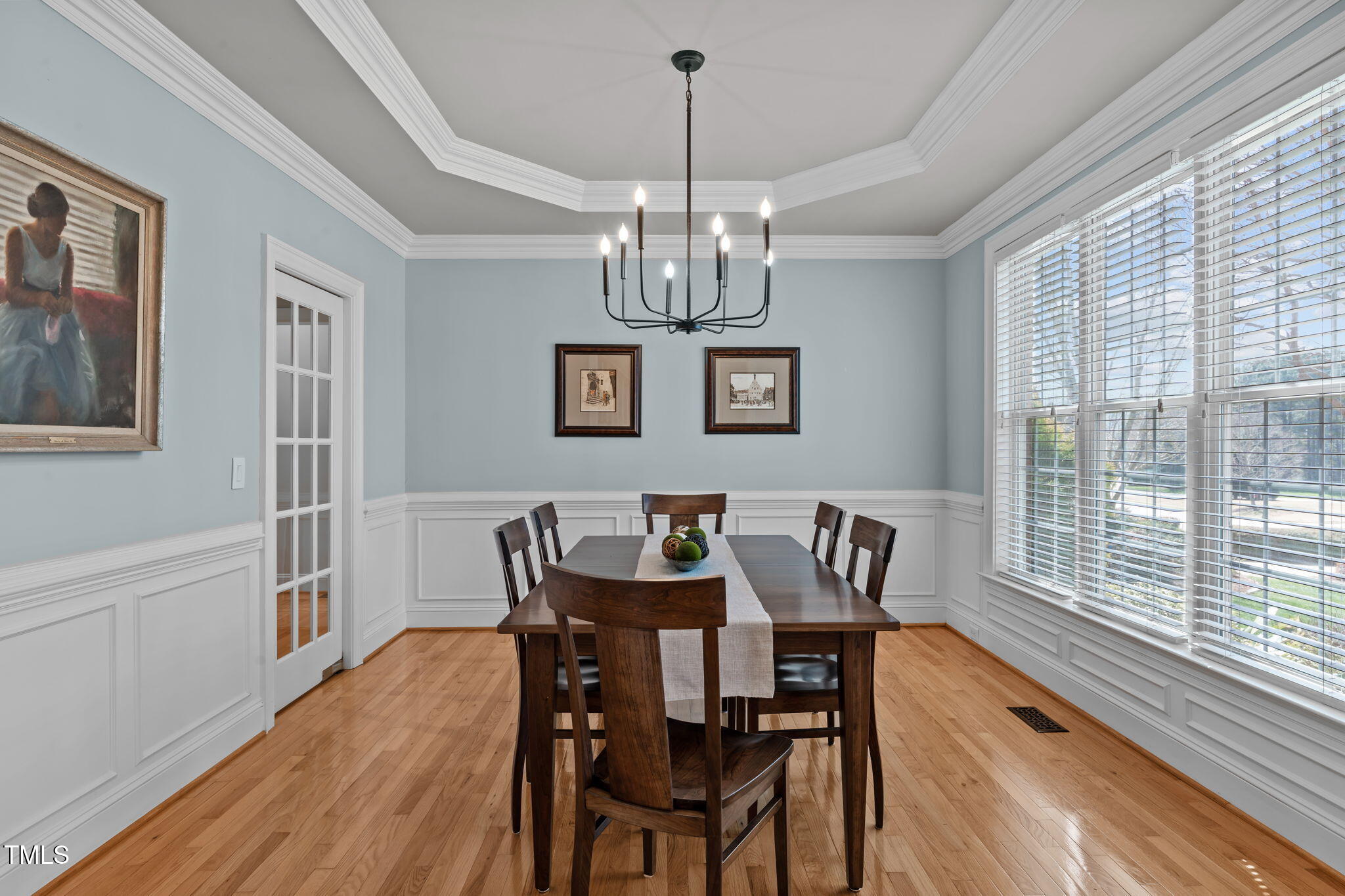 3708 Wesley Ridge Drive Apex, NC 27539 - Photo 12 of 48 a view of a dining room with furniture a chandelier and wooden floor