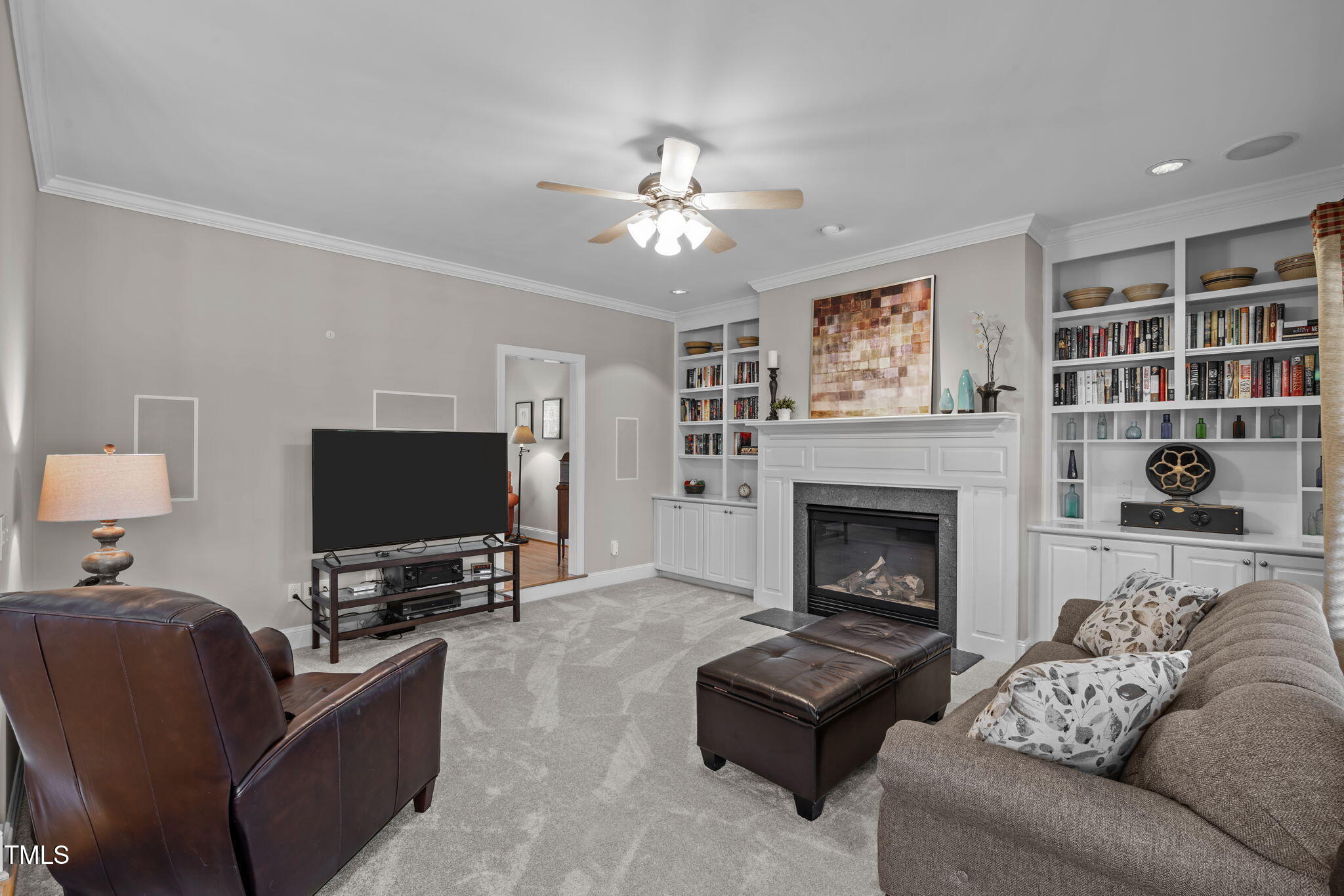3708 Wesley Ridge Drive Apex, NC 27539 - Photo 18 of 48 a living room with furniture a flat screen tv and a fireplace