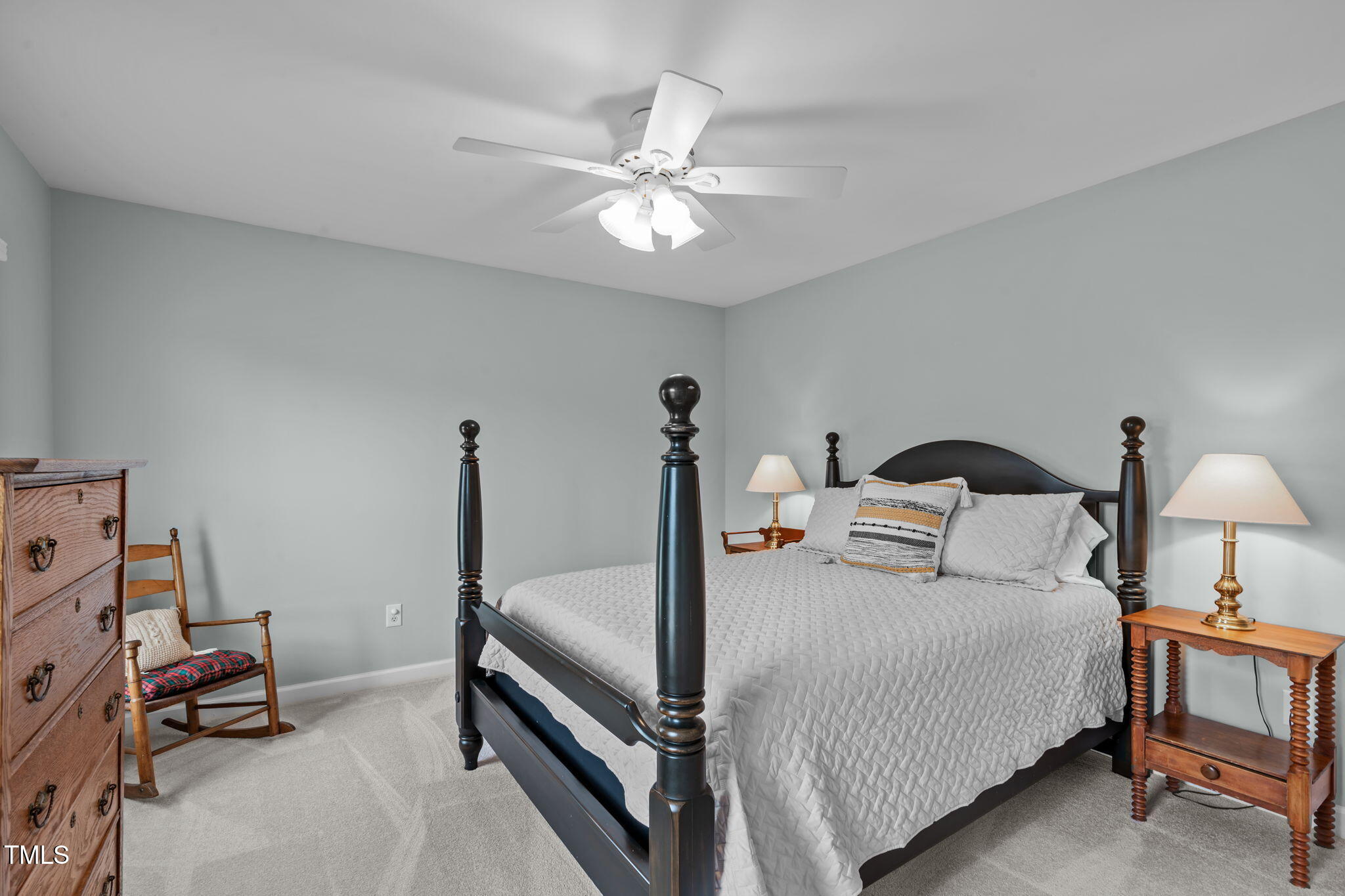 3708 Wesley Ridge Drive Apex, NC 27539 - Photo 26 of 48 a bedroom with a bed and a chandelier