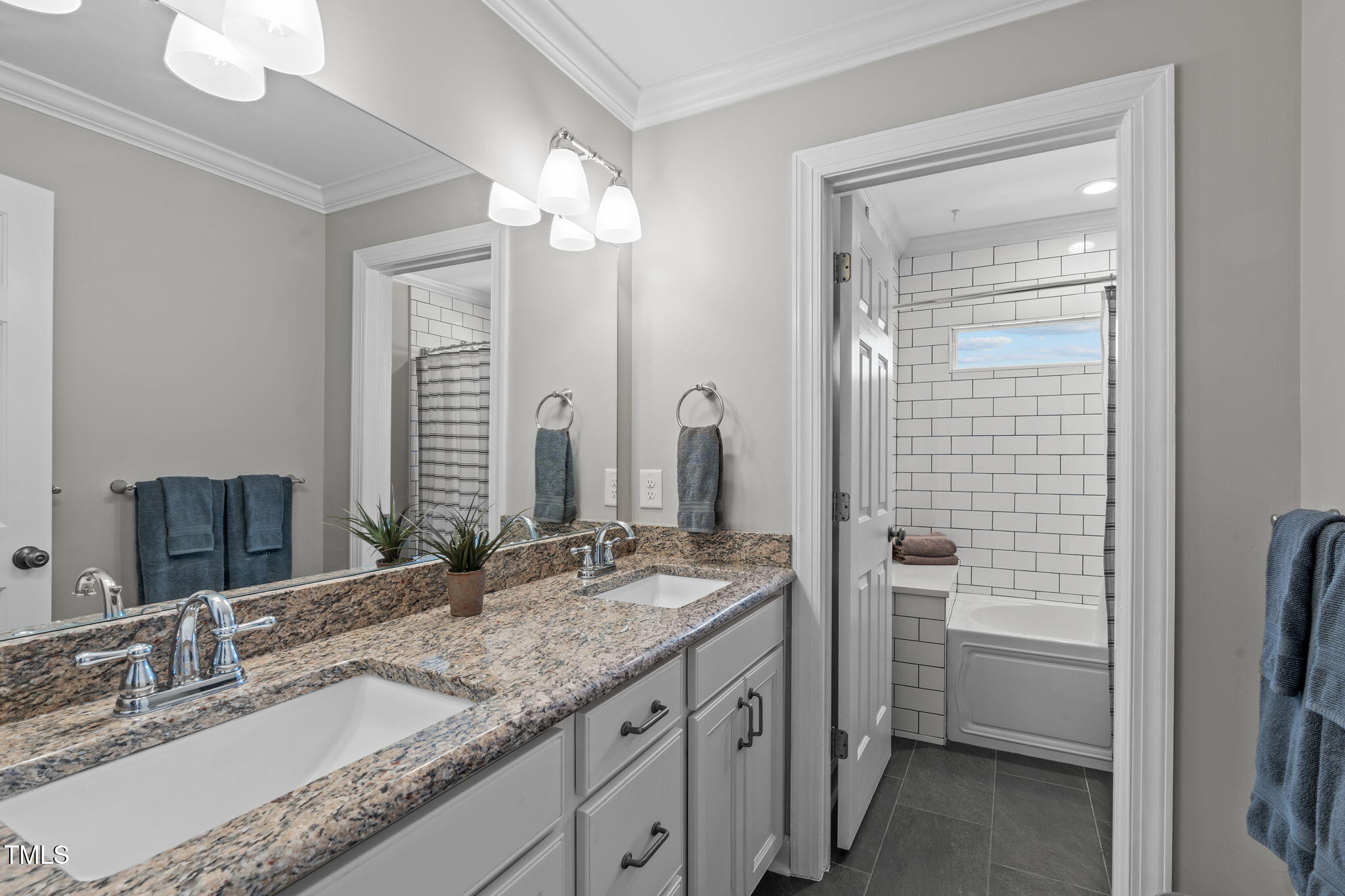 3708 Wesley Ridge Drive Apex, NC 27539 - Photo 28 of 48 a bathroom with a granite countertop sink a mirror and a shower
