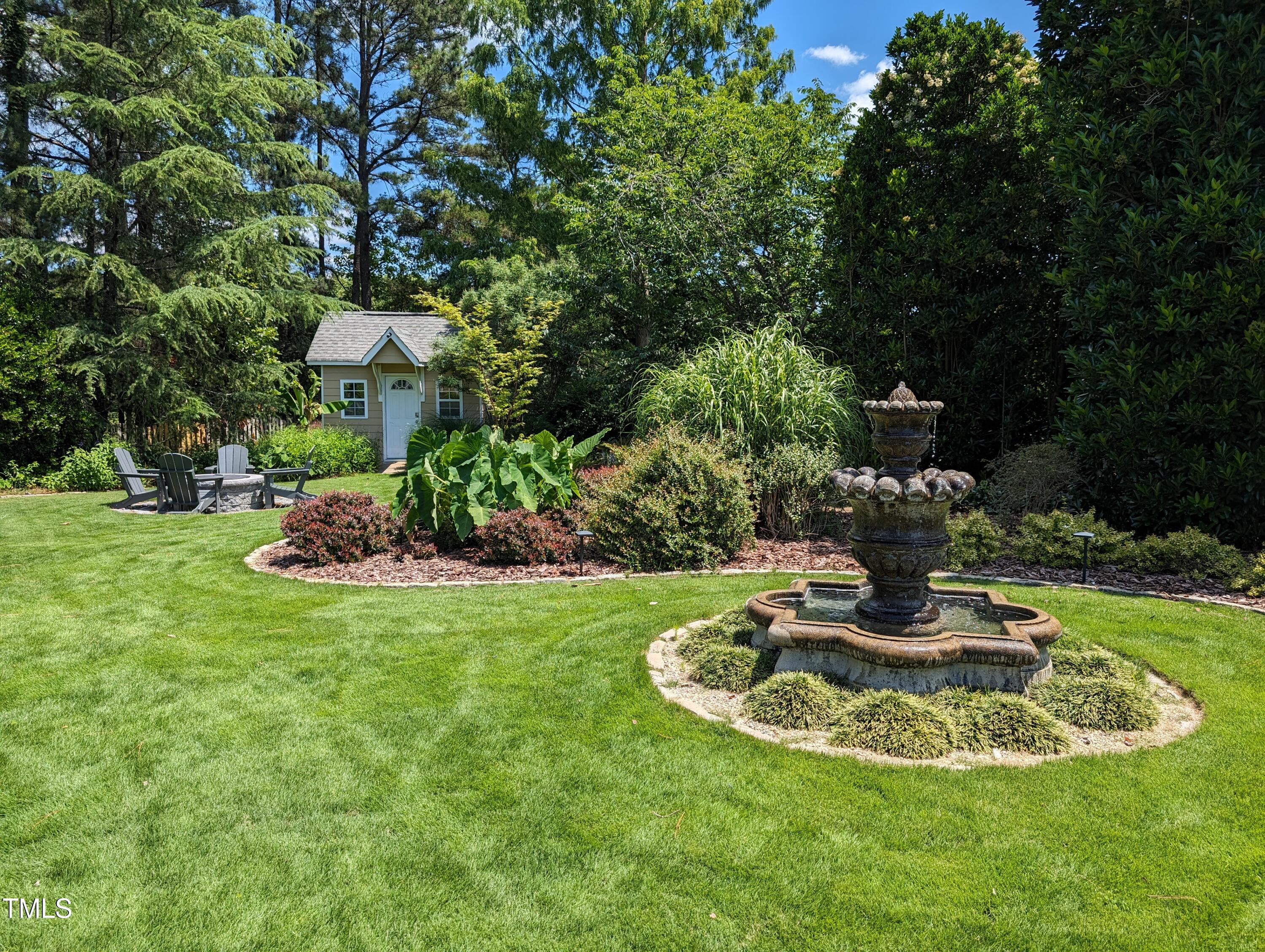 3708 Wesley Ridge Drive Apex, NC 27539 - Photo 5 of 48 a view of a fire pit with a fountain