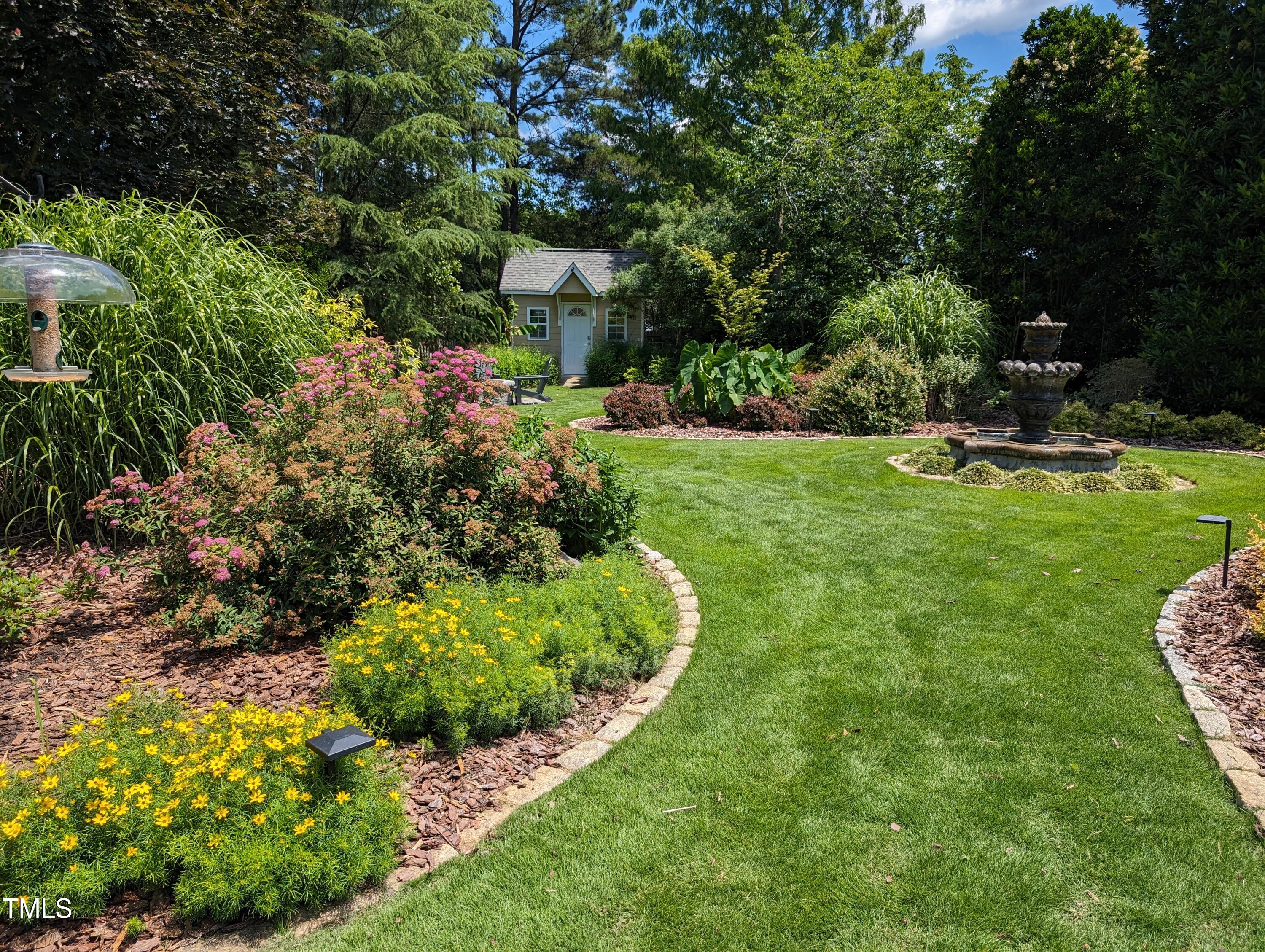 3708 Wesley Ridge Drive Apex, NC 27539 - Photo 6 of 48 a view of a garden with a bench