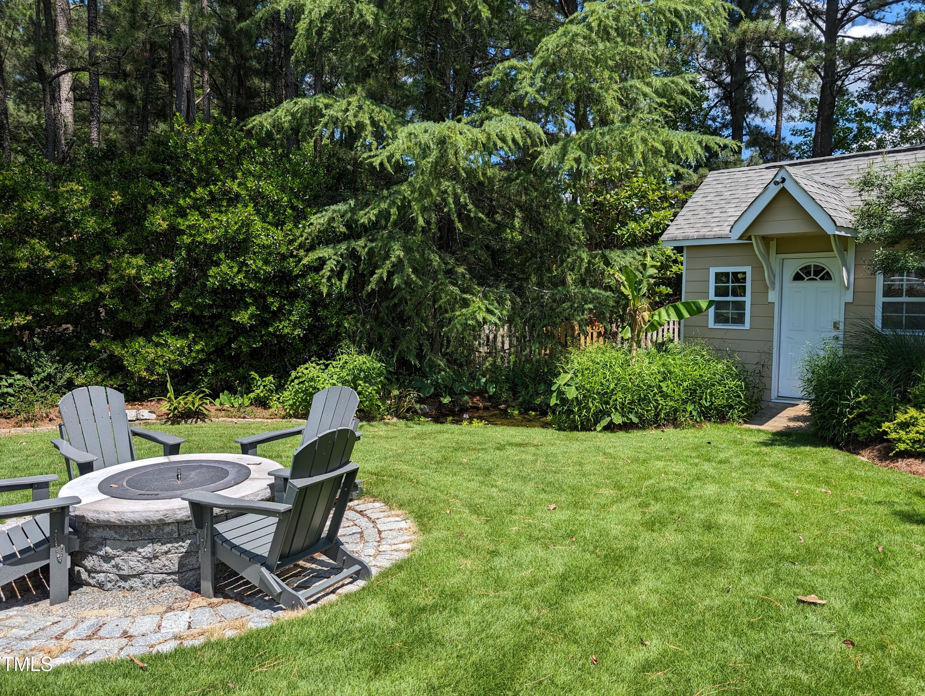 3708 Wesley Ridge Drive Apex, NC 27539 - Photo 8 of 48 a view of a chair and table in backyard