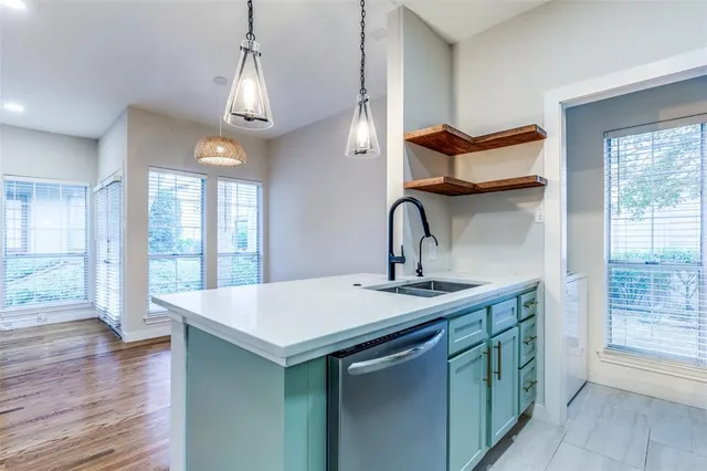 a kitchen with a sink and wooden floor