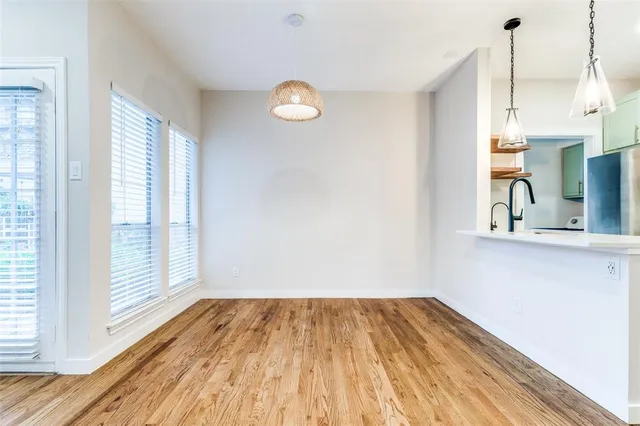 a view of a room with wooden floor and a window