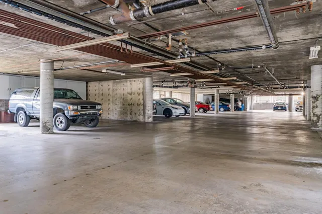 a view of parking garage with cars