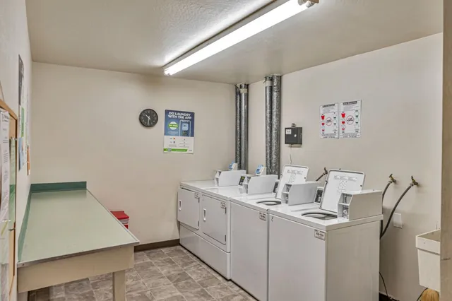 a room with a sink and a refrigerator