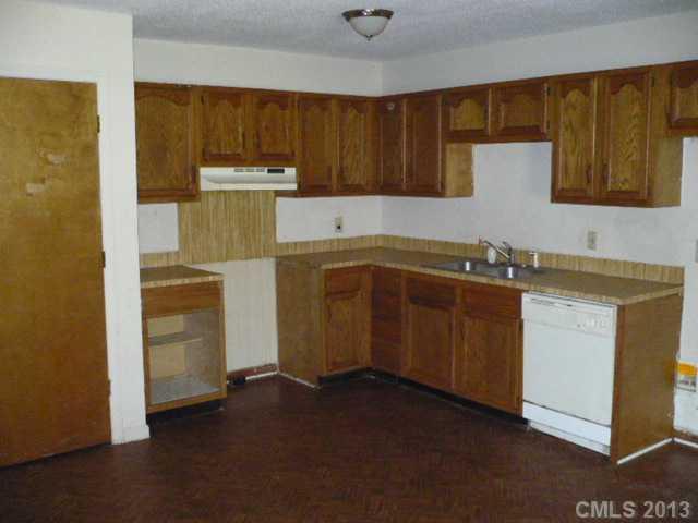 502 Rogers Lake Road Kannapolis, NC 28081 - Photo 4 of 4 a kitchen with a sink and a refrigerator