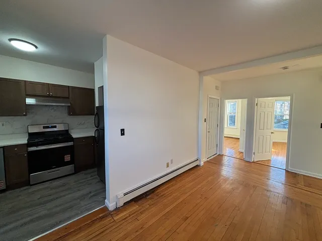 a kitchen with a refrigerator and a stove top oven