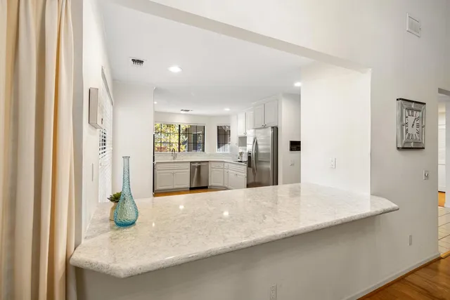 a large kitchen with cabinets and stainless steel appliances