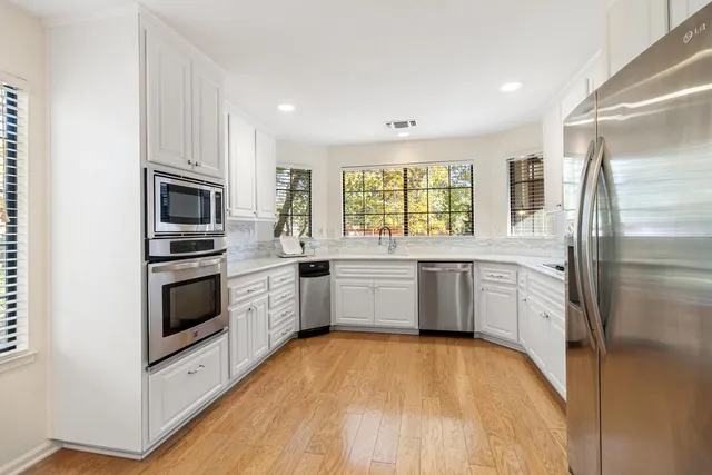 a view of kitchen with wooden floor and windows