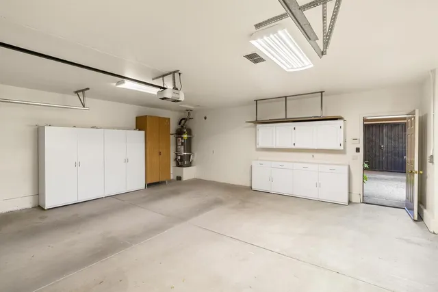 a view of a house with backyard and a tree