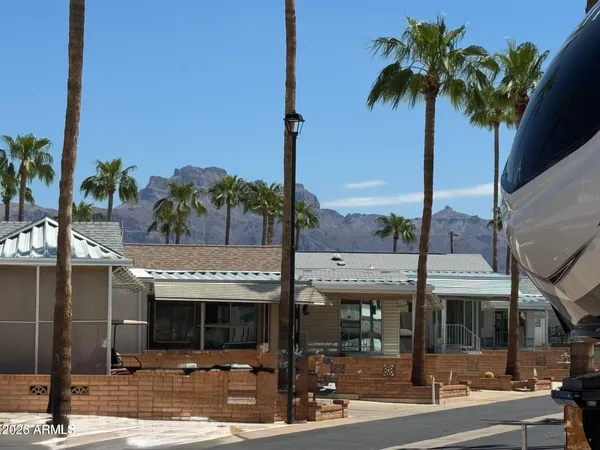 a front view of multiple building with palm tree