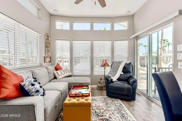 a living room with furniture and a floor to ceiling window