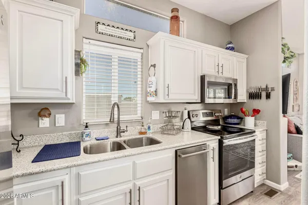 a kitchen with appliances a sink and cabinets