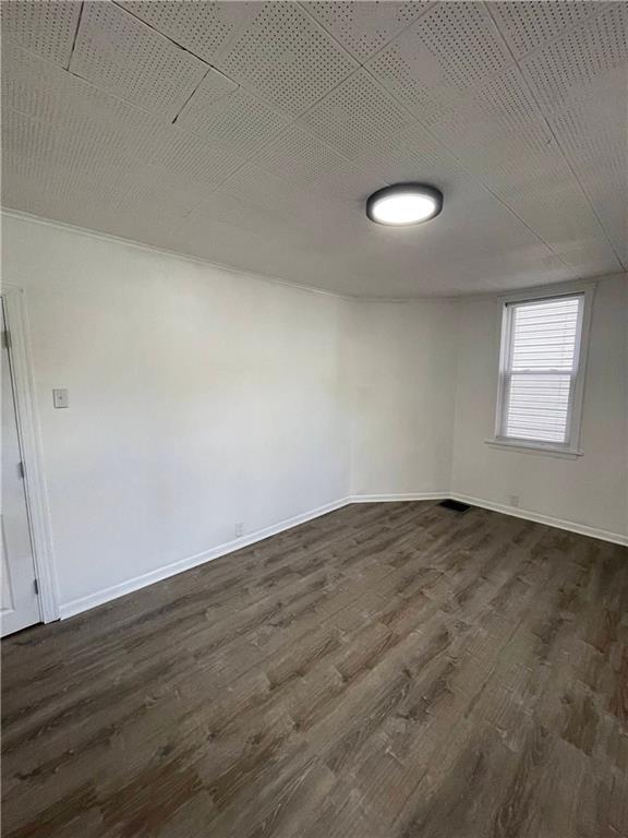 218 Four Mile Run, Unit 1 Pittsburgh, PA 15207 - Photo 11 of 14 an empty room with wooden floor and windows