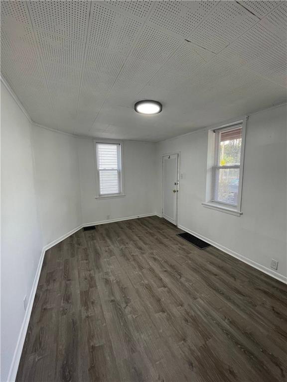 218 Four Mile Run, Unit 1 Pittsburgh, PA 15207 - Photo 3 of 14 an empty room with wooden floor and windows