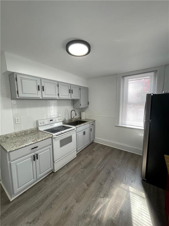 218 Four Mile Run, Unit 1 Pittsburgh, PA 15207 - Photo 5 of 14 a kitchen with stainless steel appliances granite countertop a stove a sink and a refrigerator