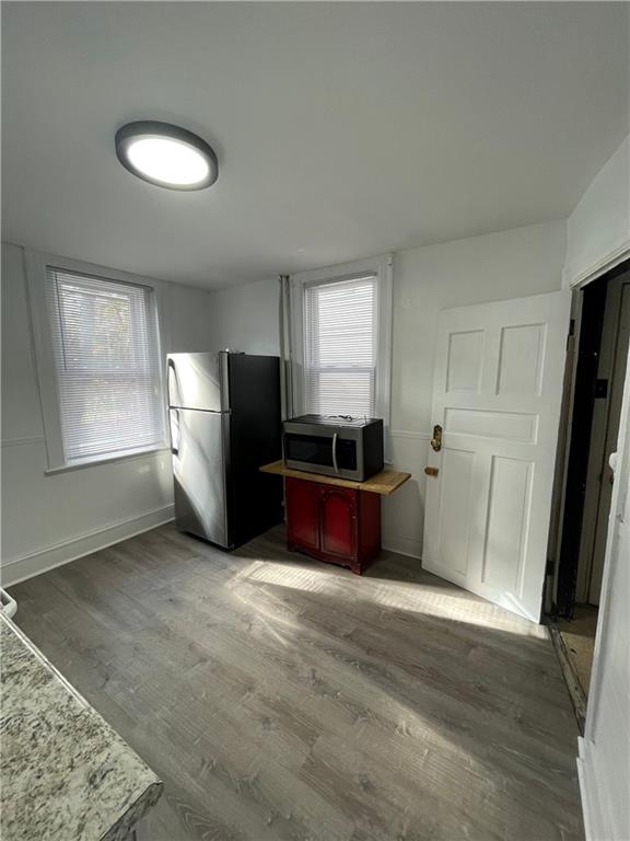 218 Four Mile Run, Unit 1 Pittsburgh, PA 15207 - Photo 6 of 14 a kitchen with granite countertop white cabinets and refrigerator