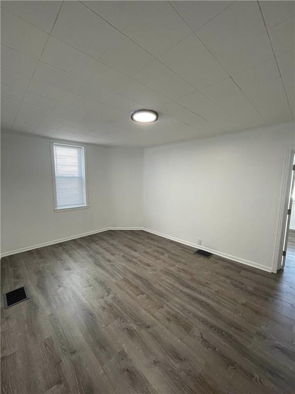 218 Four Mile Run, Unit 1 Pittsburgh, PA 15207 - Photo 8 of 14 an empty room with wooden floor and windows