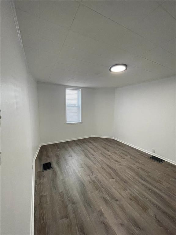 218 Four Mile Run, Unit 1 Pittsburgh, PA 15207 - Photo 10 of 14 an empty room with wooden floor and windows