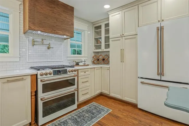 a kitchen with white cabinets and white appliances