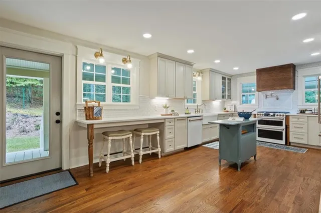 a kitchen with a sink cabinets and wooden floor