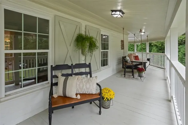 a living room filled with furniture and a floor to ceiling window
