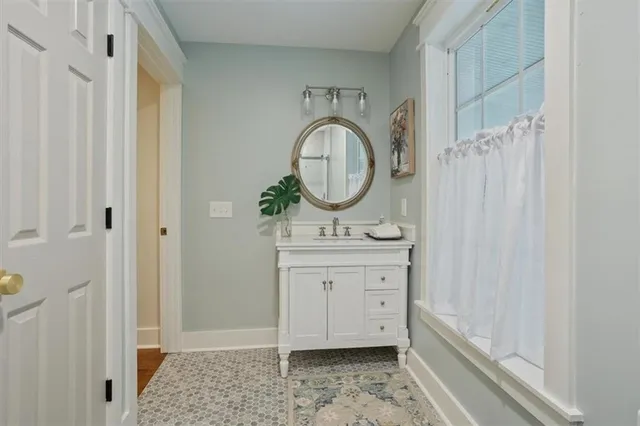 a bathroom with a sink a mirror and a shower curtain