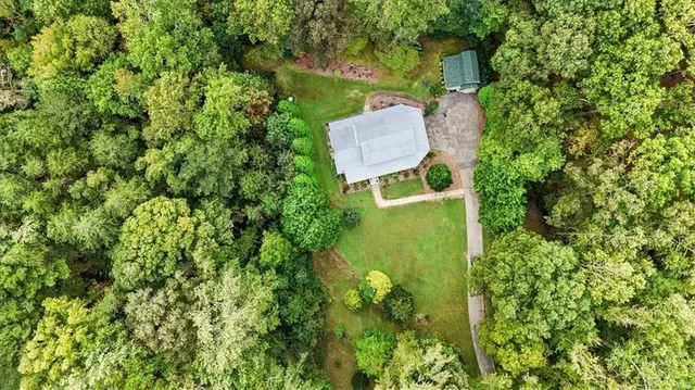 a backyard of a house with outdoor seating and yard