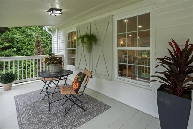 a view of a house with a porch and furniture