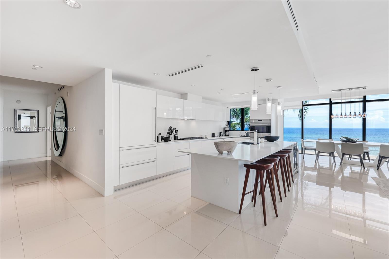 2205 South Surf Road, Unit 3A Hollywood, FL 33019 - Photo 17 of 58 a kitchen with a table chairs and a view of living room