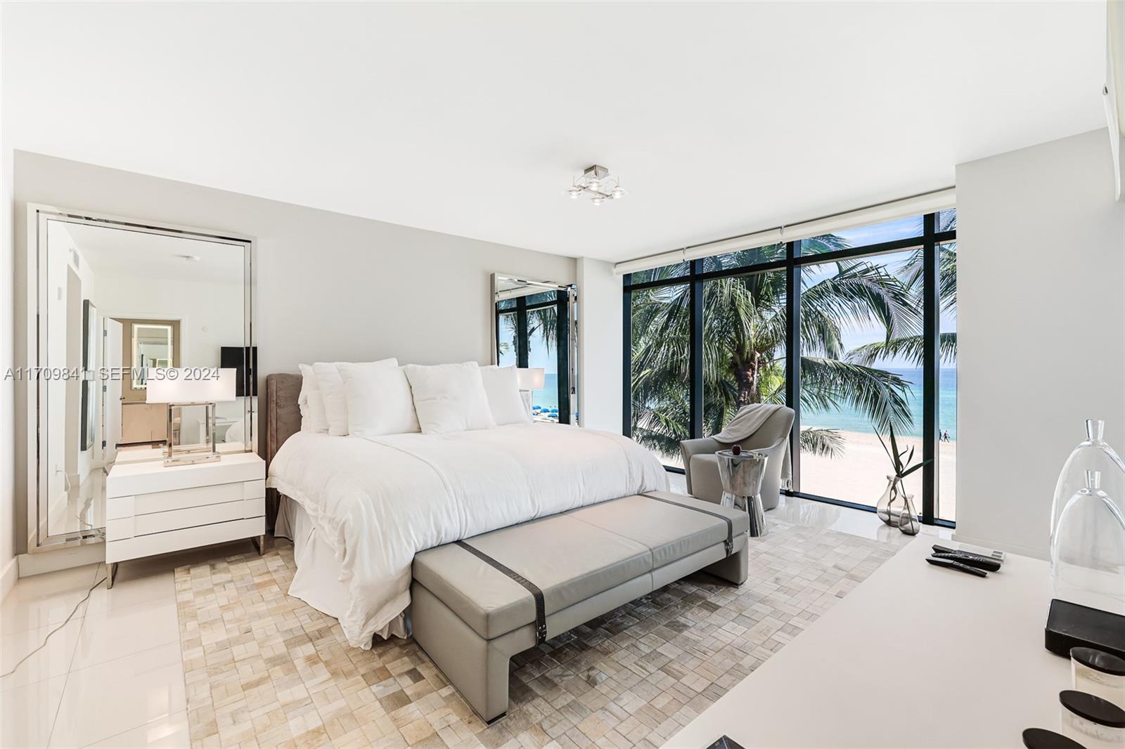 2205 South Surf Road, Unit 3A Hollywood, FL 33019 - Photo 18 of 58 a bedroom with a bed lamp and a large window