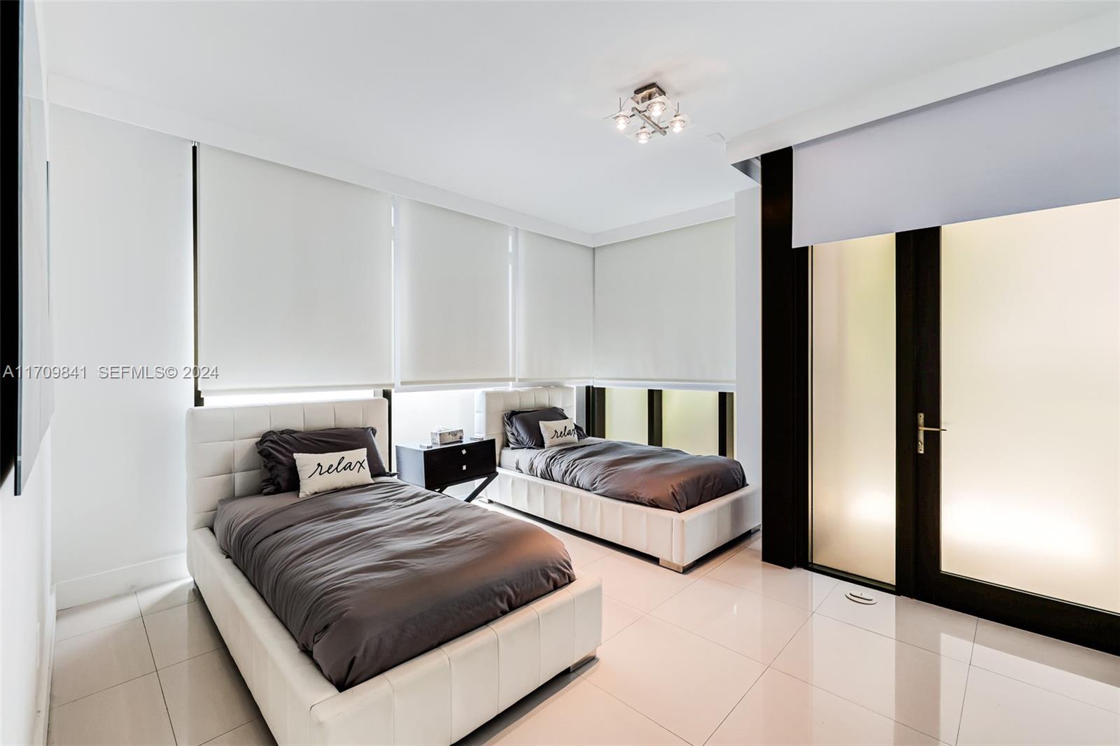 2205 South Surf Road, Unit 3A Hollywood, FL 33019 - Photo 27 of 58 a bedroom with double bed and a large mirror