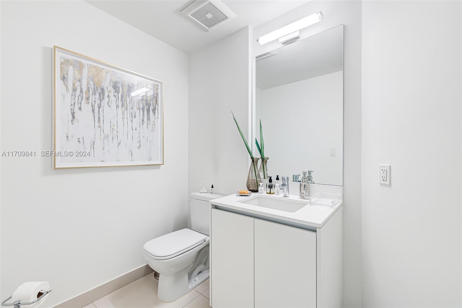 2205 South Surf Road, Unit 3A Hollywood, FL 33019 - Photo 33 of 58 a bathroom with a sink vanity mirror and toilet