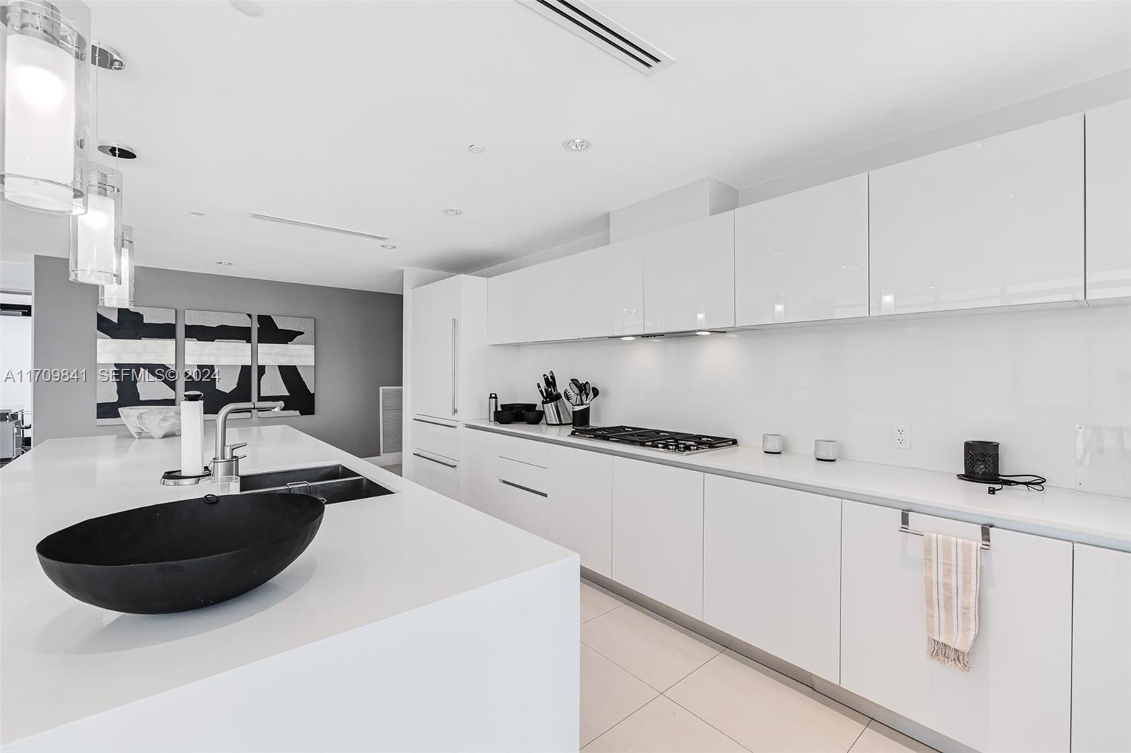 2205 South Surf Road, Unit 3A Hollywood, FL 33019 - Photo 10 of 58 a kitchen with stainless steel appliances a sink a stove and white cabinets