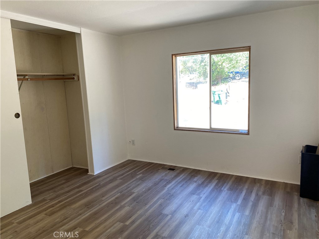 14650 Nimshew Road Magalia, CA 95954 - Photo 11 of 22 an empty room with wooden floor closet and windows