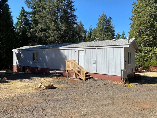 a view of backyard with a chair and potted plants