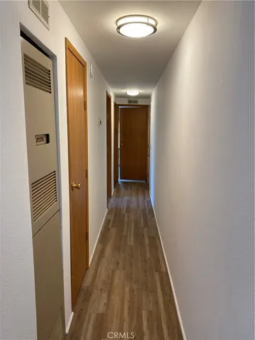 a view of hallway with wooden floor