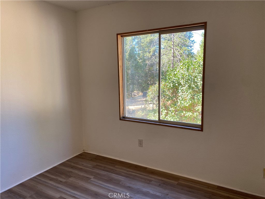 14650 Nimshew Road Magalia, CA 95954 - Photo 9 of 22 a view of a small space with wooden floor and a window