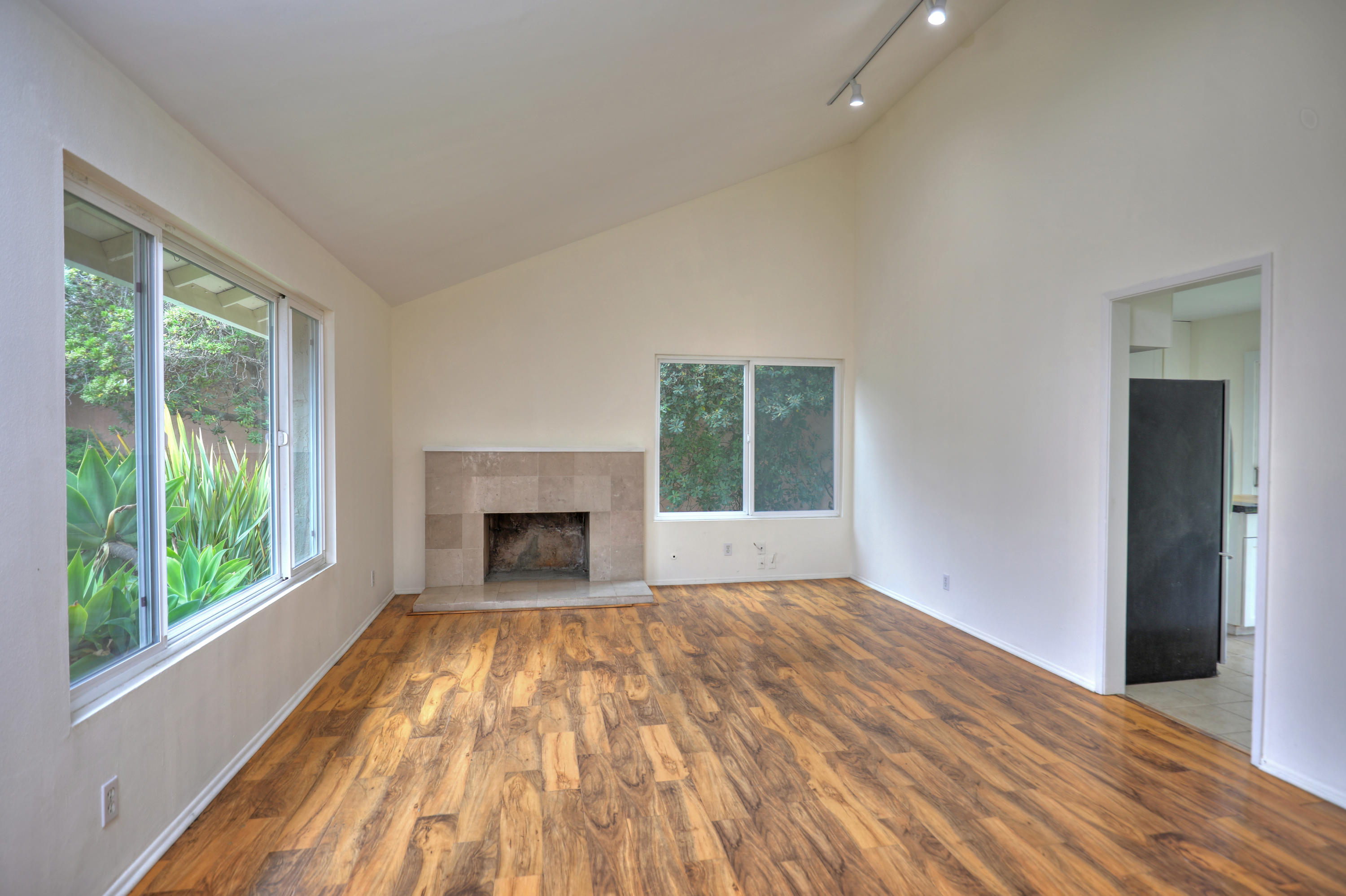 7320 Davenport Road Goleta, CA 93117 - Photo 1 of 18 a view of empty room with wooden floor and fireplace