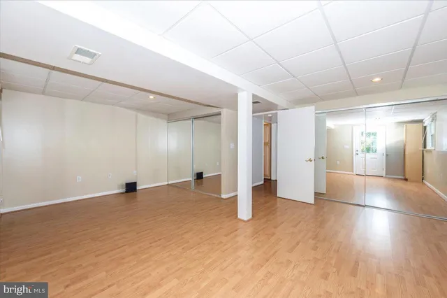 a view of backyard with a deck and wooden floor