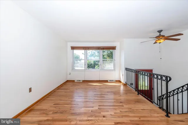 a view of a livingroom with wooden floor and a window