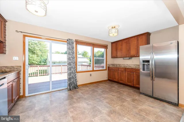 a kitchen with stainless steel appliances a refrigerator and wooden cabinets