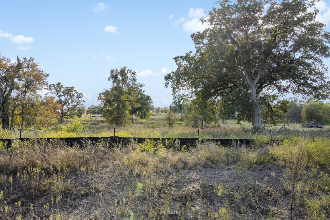 897 Ferguson Loop Dale Dale, TX 78616 - Photo 1 of 8 a view of a lake with outdoor space and trees